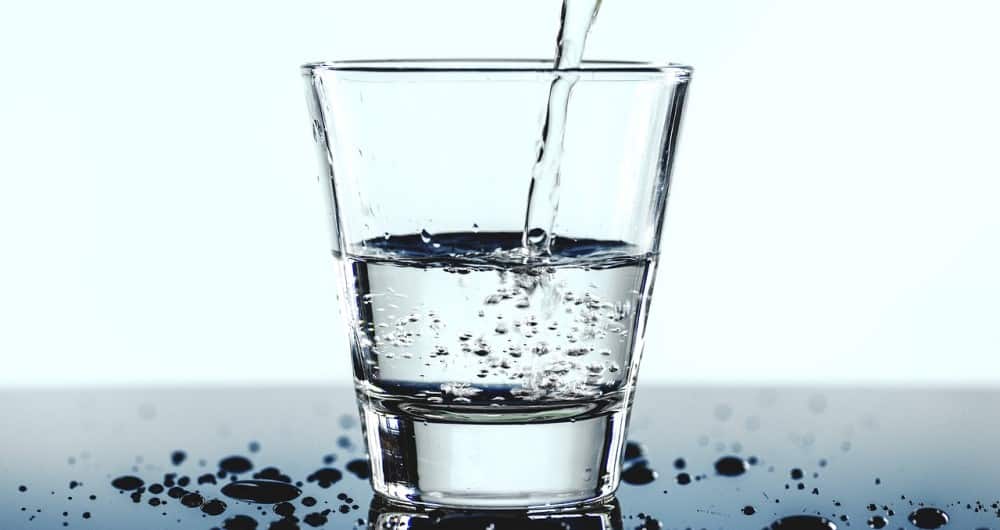 A glass with water puring in