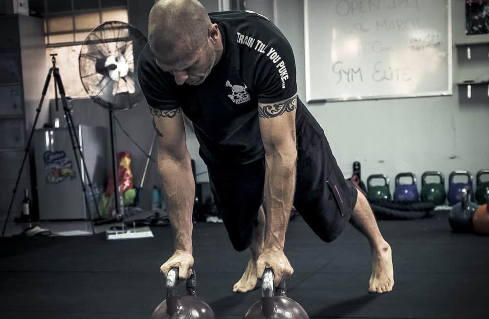Man working out with kettlebells for HST Training results