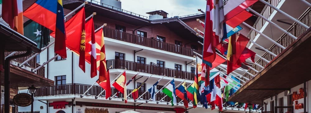 Multinational flags hanging from buildings representive different languages and countries